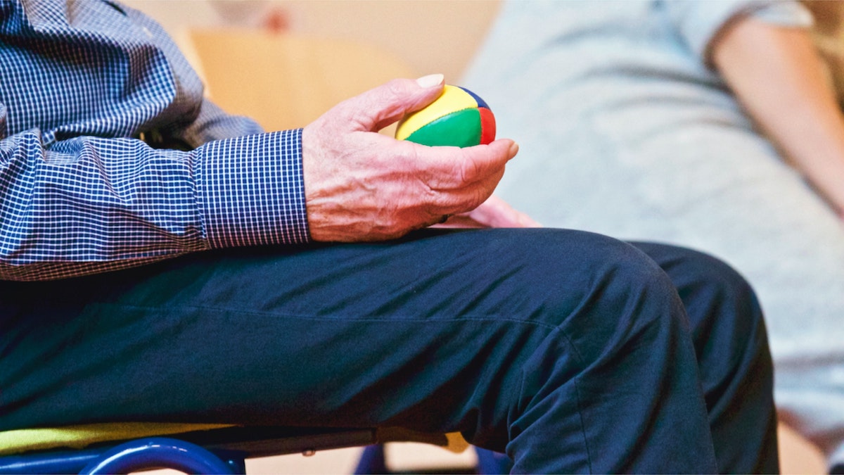 man holding therapy ball